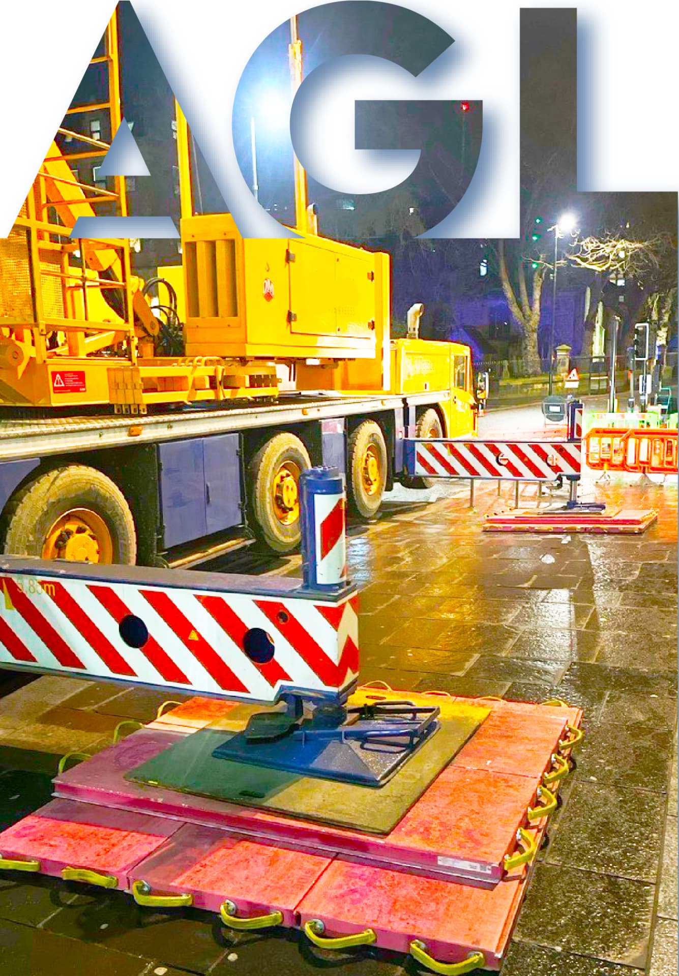 AGL crane set up at night with outrigger mats and barriers protecting new council pavement