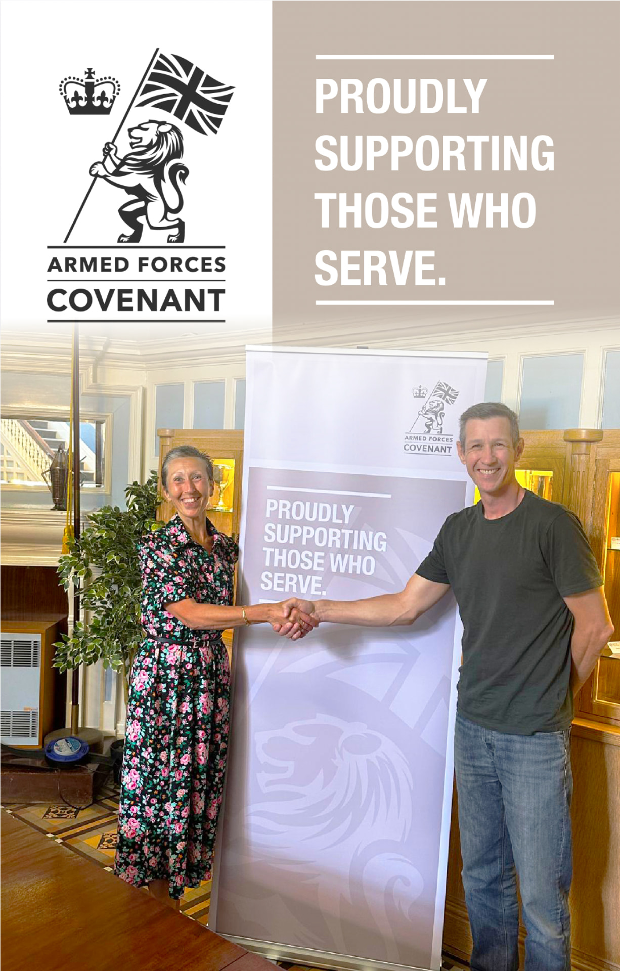 Anatree's Barry Light shaking hands with Pauline King, Yorkshire Regional Director for the Armed Forces Covenant, in front of a 'Proudly supporting those who serve' banner